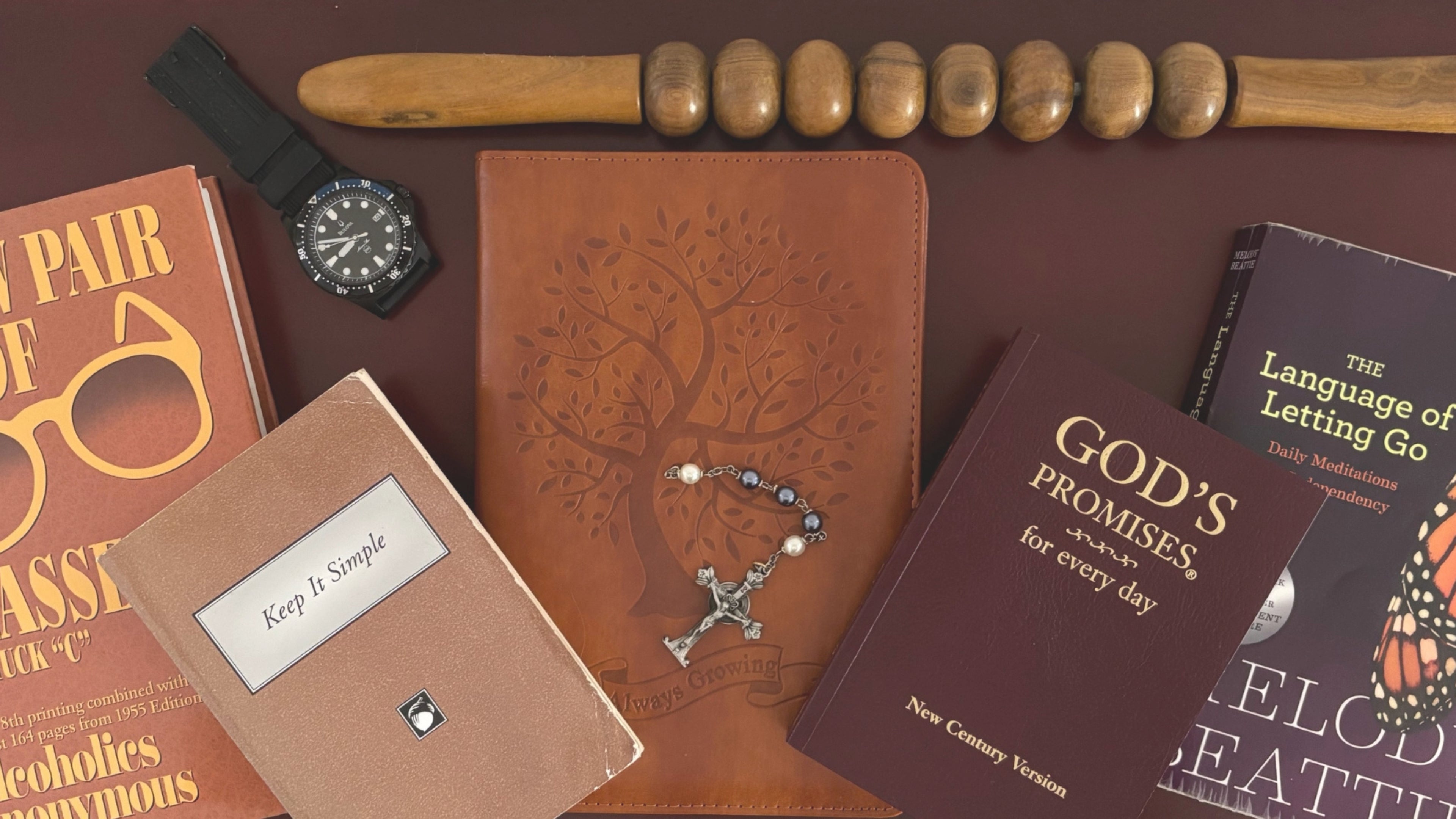 Collection of leather-bound books and items on a brown surface