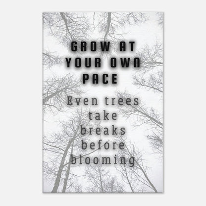 Bare branches and bold lettering on a clean canvas reminding viewers to grow at their own pace

