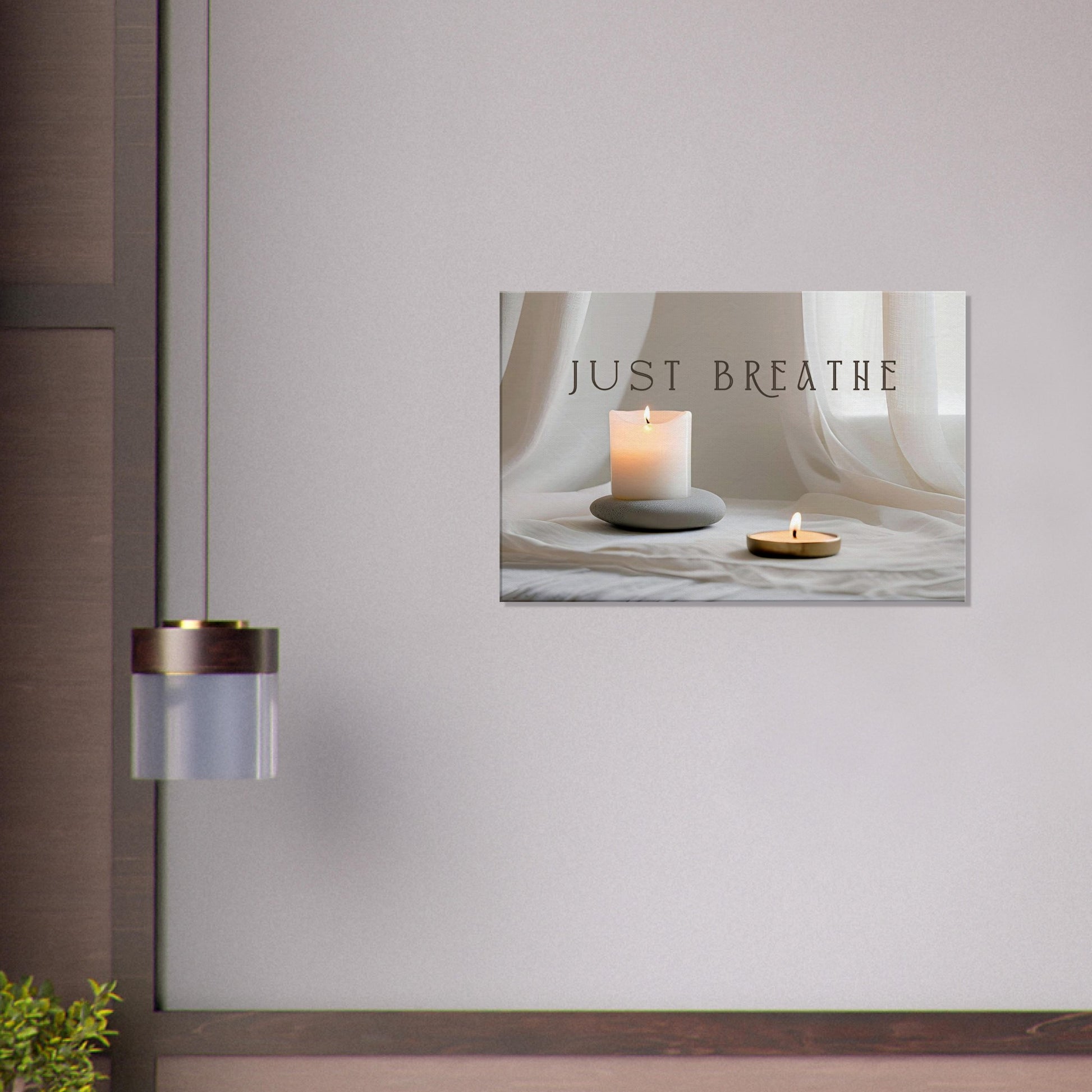 Sobriety canvas wall art with beige satin sheet background with candles and a quote "Just Breathe" in the middle.  This recovery art is hanging on a light purple wall in a meditation room.