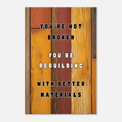 Motivational canvas wall art with quote “You're Not Broken” on rustic brown wood background.