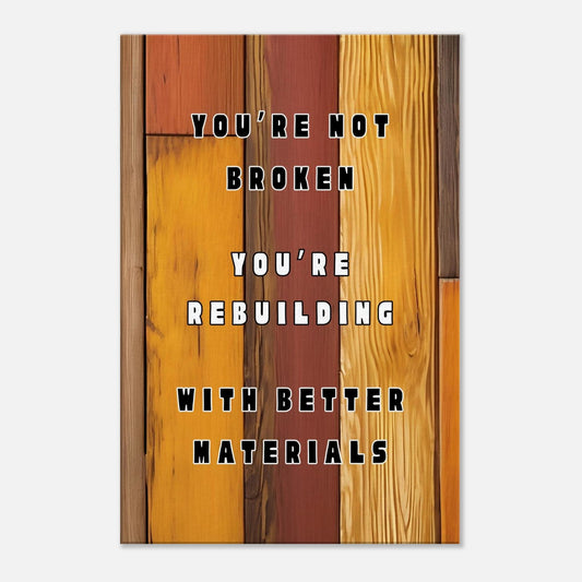 Motivational canvas wall art with quote “You're Not Broken” on rustic brown wood background.