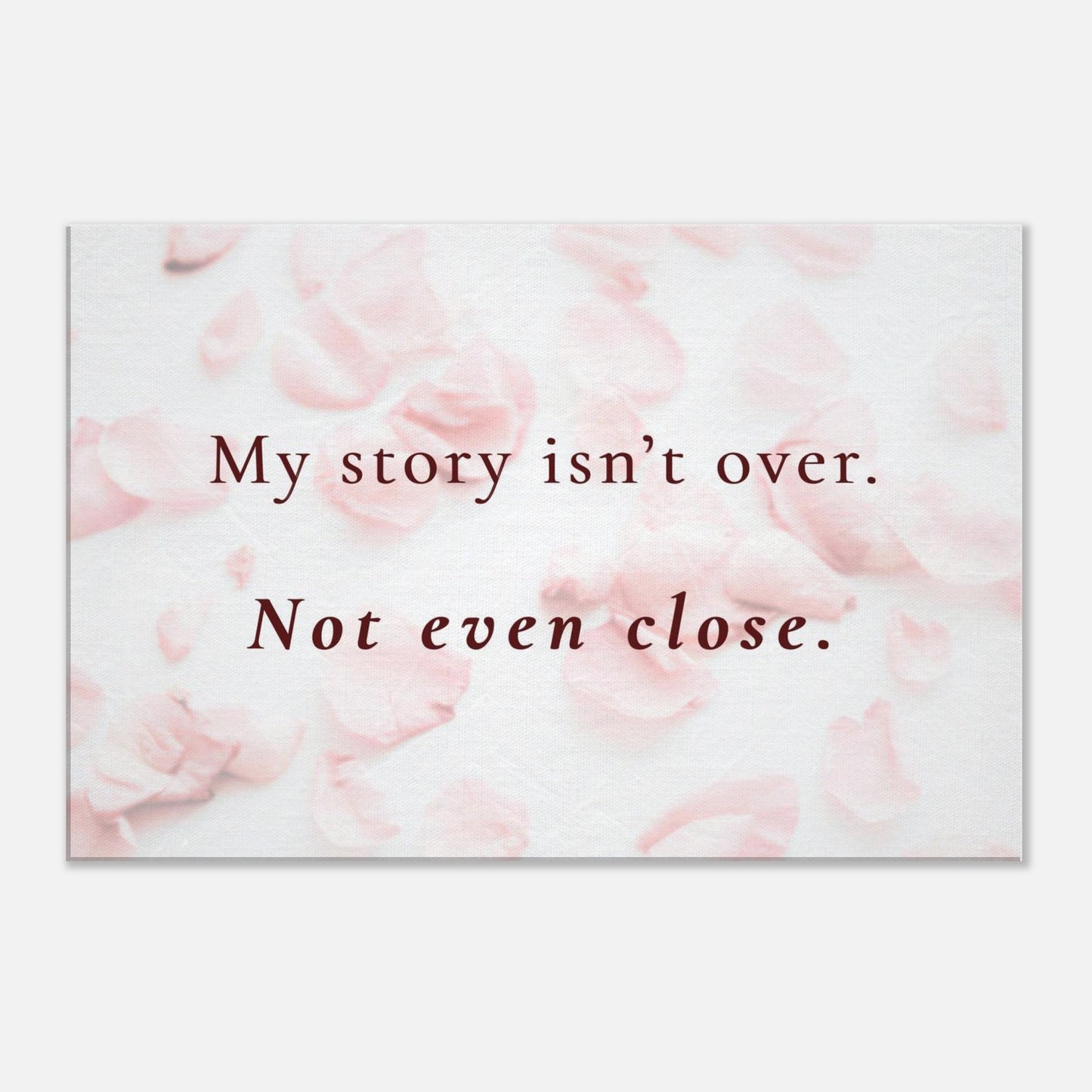 Recovery canvas wall art with the quote “My story isn’t over. Not even close” on soft pink rose petal background


